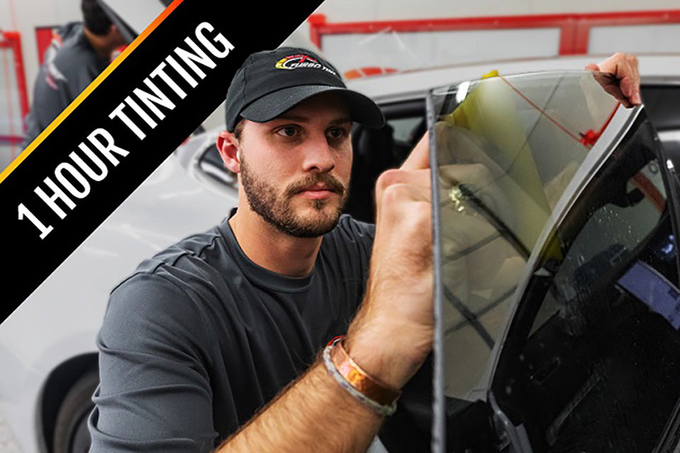 Turbo Tint installer fitting window film on a car door in about an hour